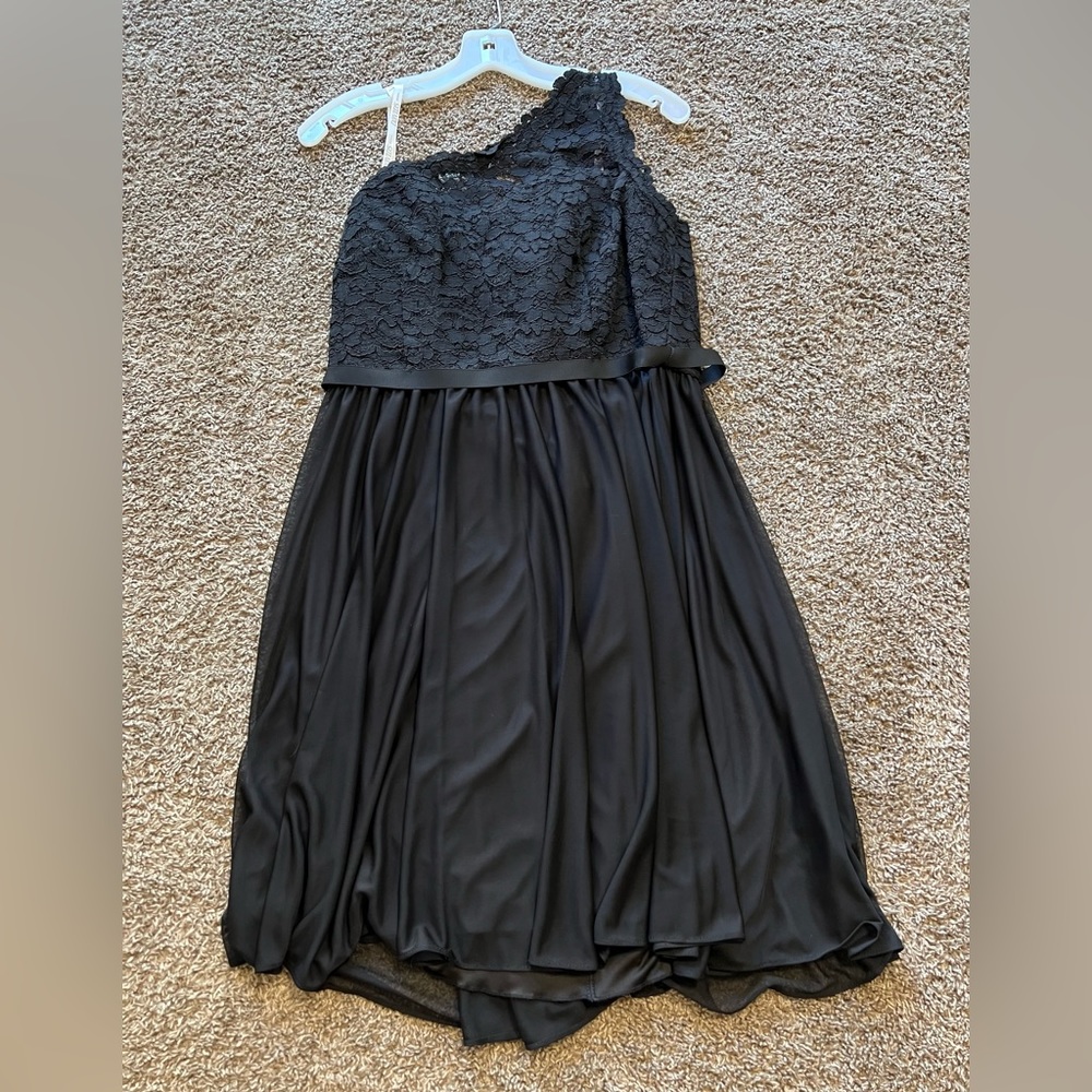 NWT black size 12 dress. Never worn. I’m 5’8” and it goes mid thigh.